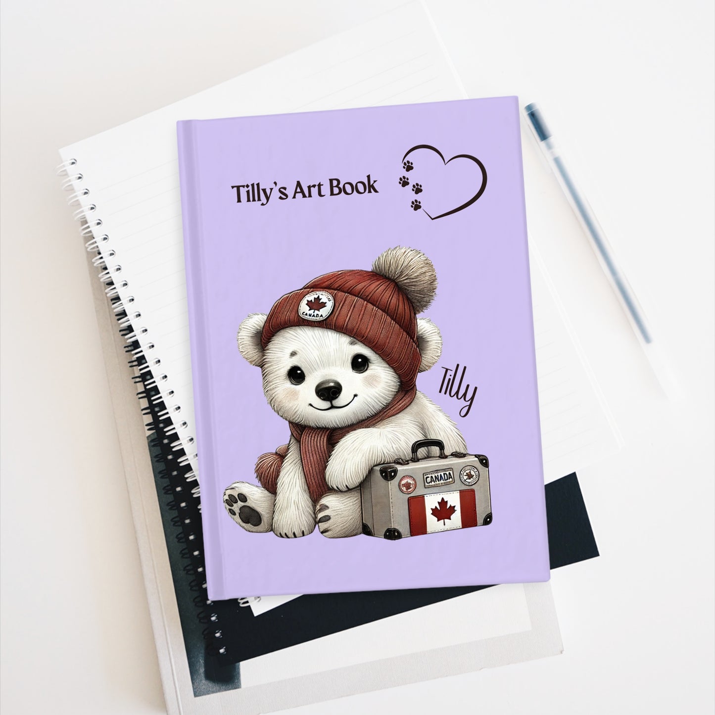 Notebook with a bear illustration and 'Tilly's Art Book' text on a white background