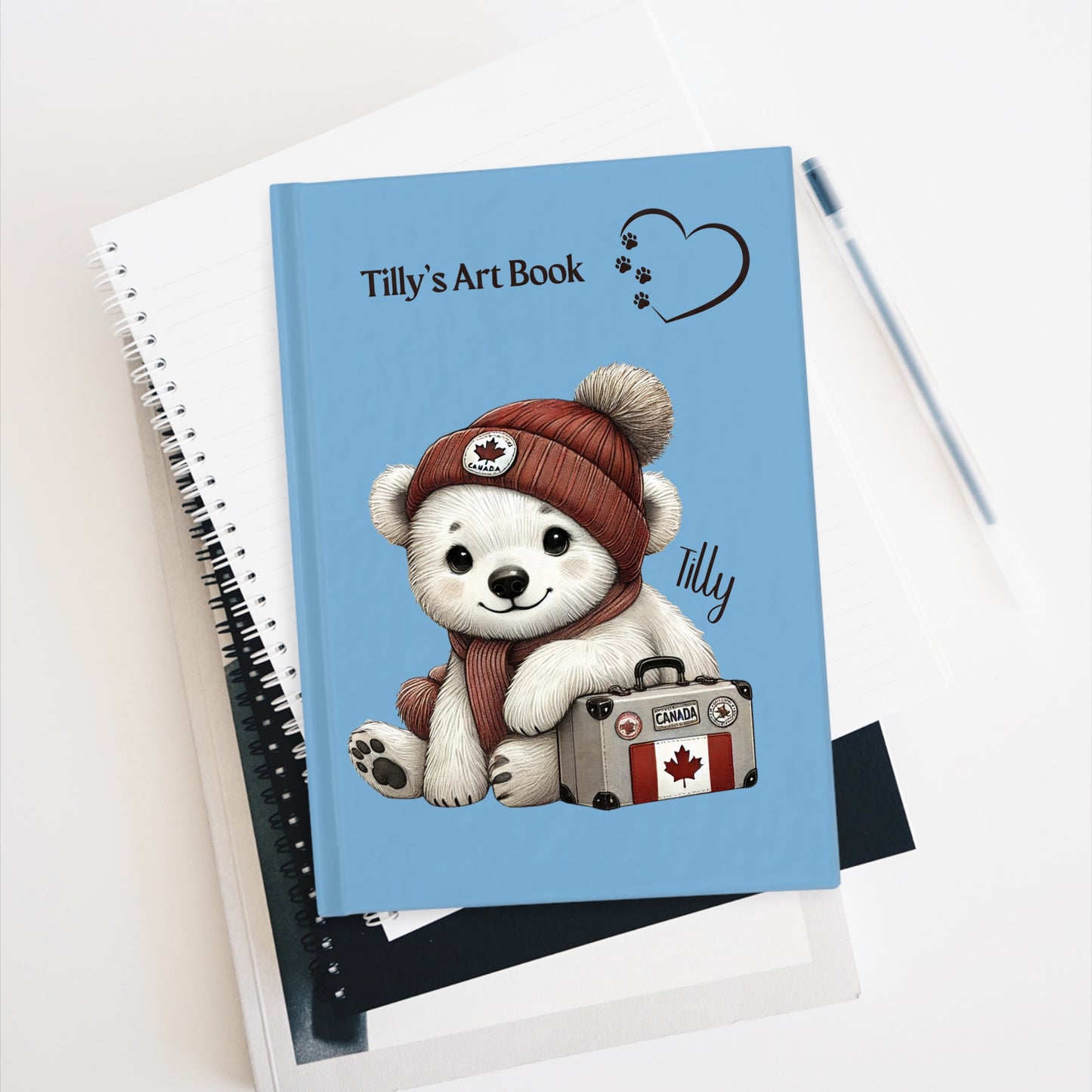 Notebook with a polar bear illustration and 'Tilly's Art Book' text on a white background