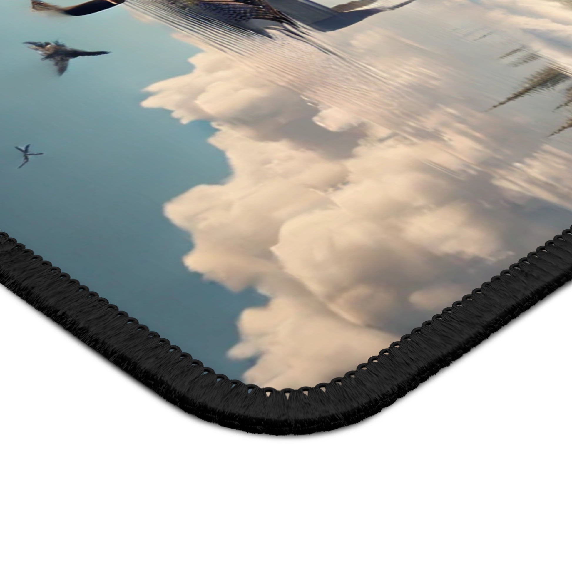 Reflective surface with clouds and a black border mousepad