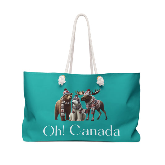 Teal weekender tote bag with Canadian-themed design featuring bears, moose, and caribou with scarves and hats on a white background.