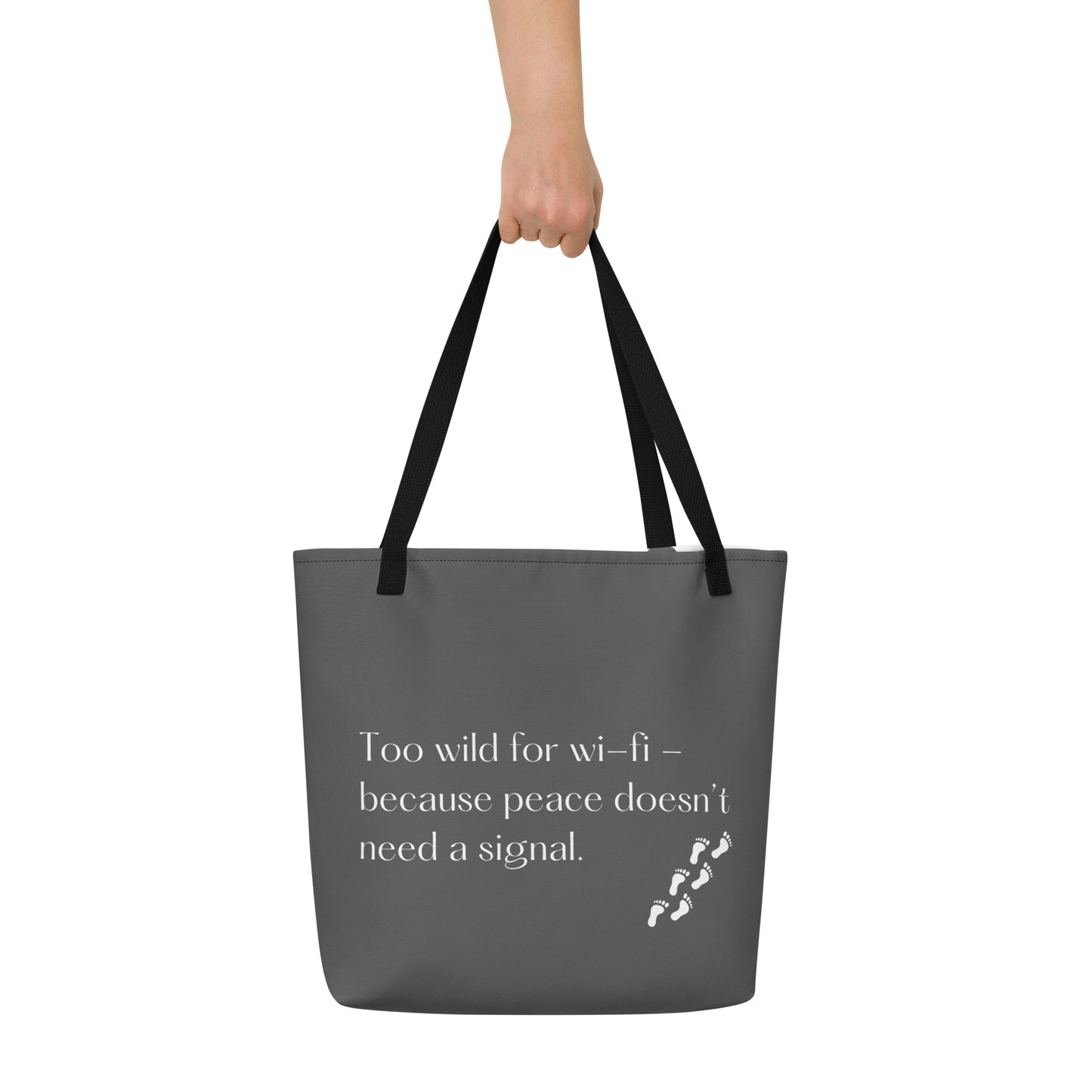 holding grey tote bag, back side