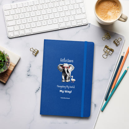 Blue notebook with elephant illustration and text on a marble desk with office supplies