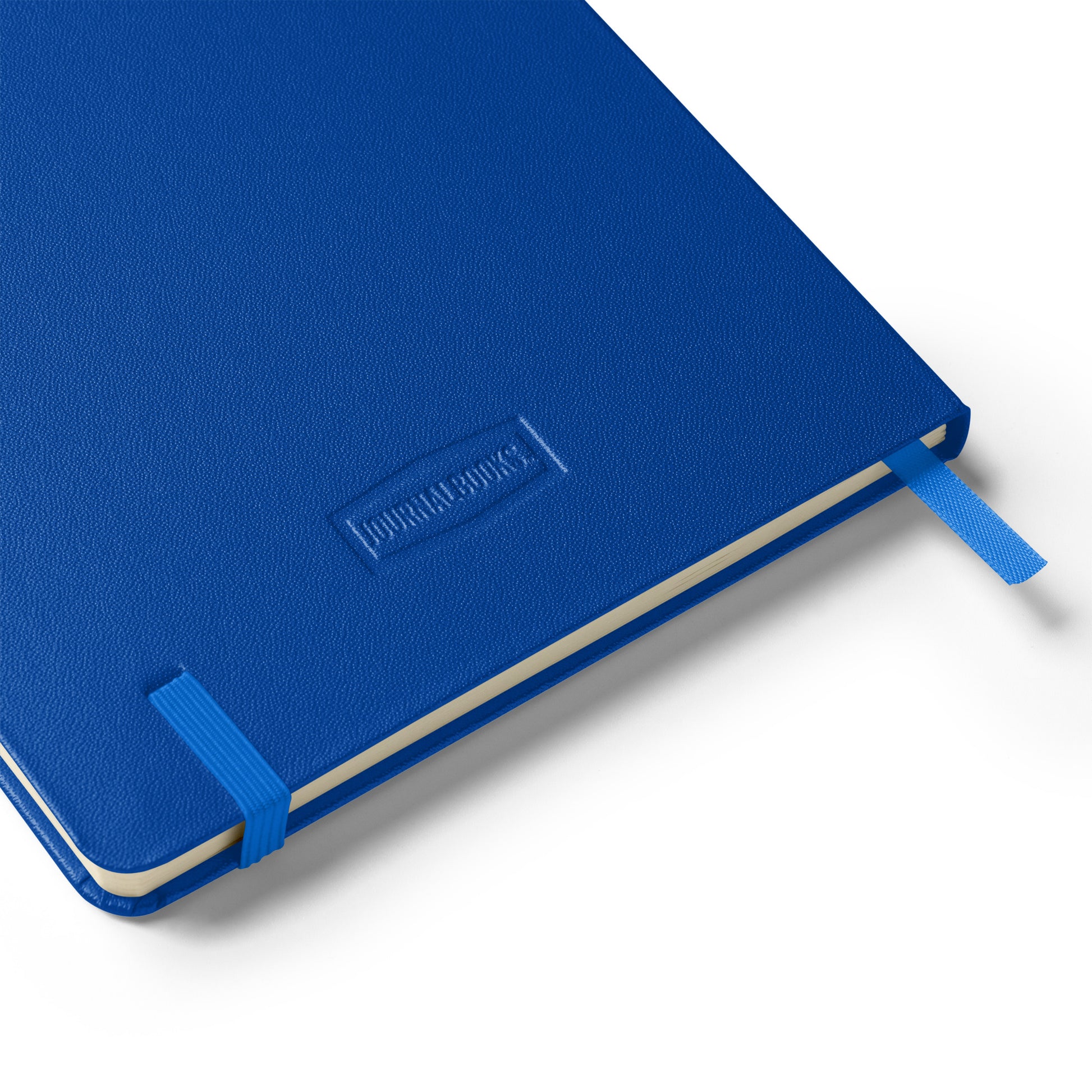 Blue notebook with blue elastic band, blue silk bookmark lying flat on a white background