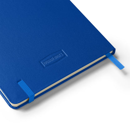 Blue notebook with blue elastic band, blue silk bookmark lying flat on a white background