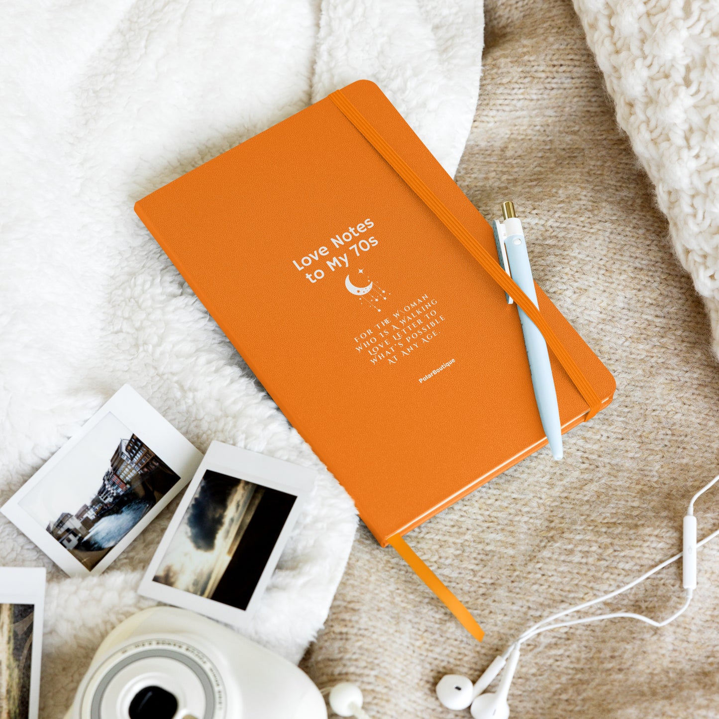 Love Notes to My 70s Journal in orange with pen lying on soft blanket