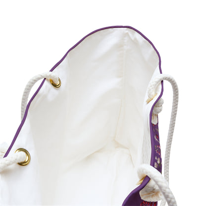 White drawstring bag with purple accents and gold grommets